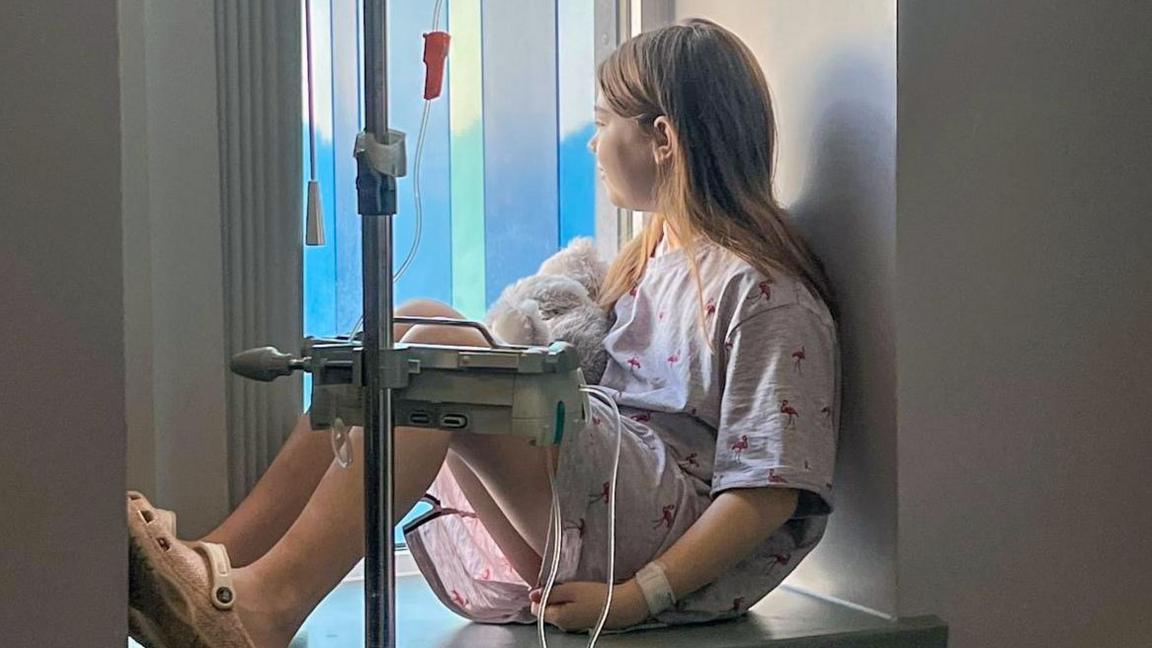 Hastane penceresinde damda tedavi gören genç kanser hastası